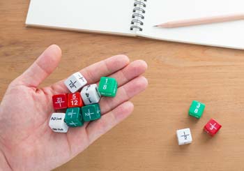 Dice with fractions being held in hand